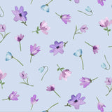 Light blue fabric with a repeating watercolor floral pattern of purple, pink, and blue flowers with green stems, shown with a wooden ruler at the bottom for scale.
