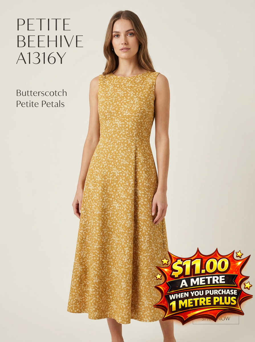 Woman in a butterscotch yellow dress with petite white floral petals, featuring a sleeveless design and flared midi skirt.