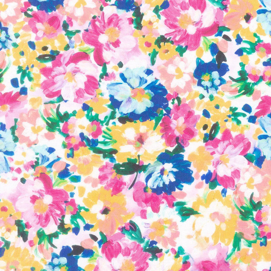 A close-up of a floral fabric pattern with pink, blue, yellow, and white flowers on a white background, with a ruler scale visible along the bottom edge.
