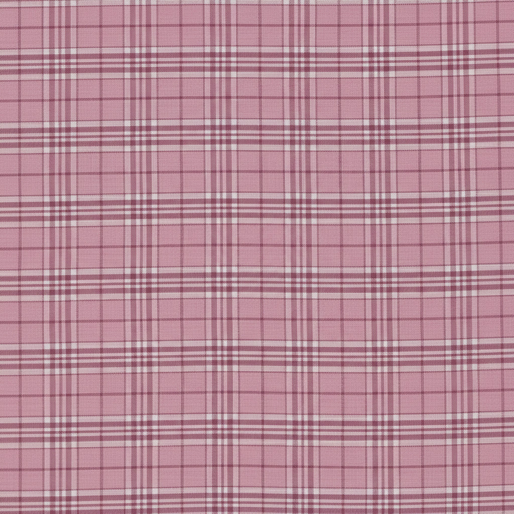 A close-up of a pink plaid fabric pattern with intersecting white and darker pink lines.