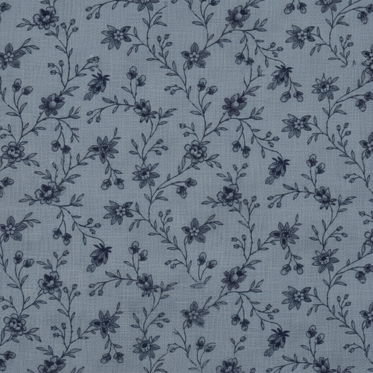 A close-up of a fabric or wallpaper pattern featuring a delicate, dark navy floral vine design on a muted slate blue-gray background.