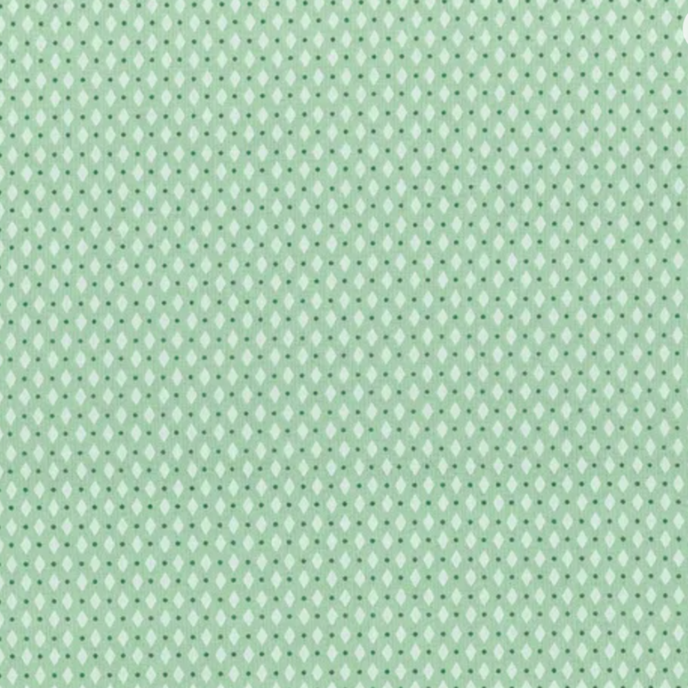 A close-up of a repeating fabric or material pattern in pale mint green and white, showing small diamond-like shapes arranged in a grid.