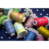 Assortment of colorful Silco™ 35wt lint-free cotton thread spools in solid and variegated shades.