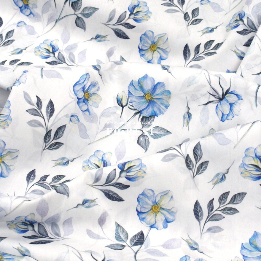 Floral pattern with blue flowers and green leaves on a white background