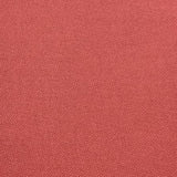 A close-up texture shot of a woven fabric in a muted terracotta or dusty rose red color.