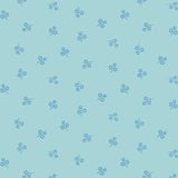 Light blue fabric with a repeating pattern of small blue floral sprigs, shown with a ruler along the bottom edge for scale.